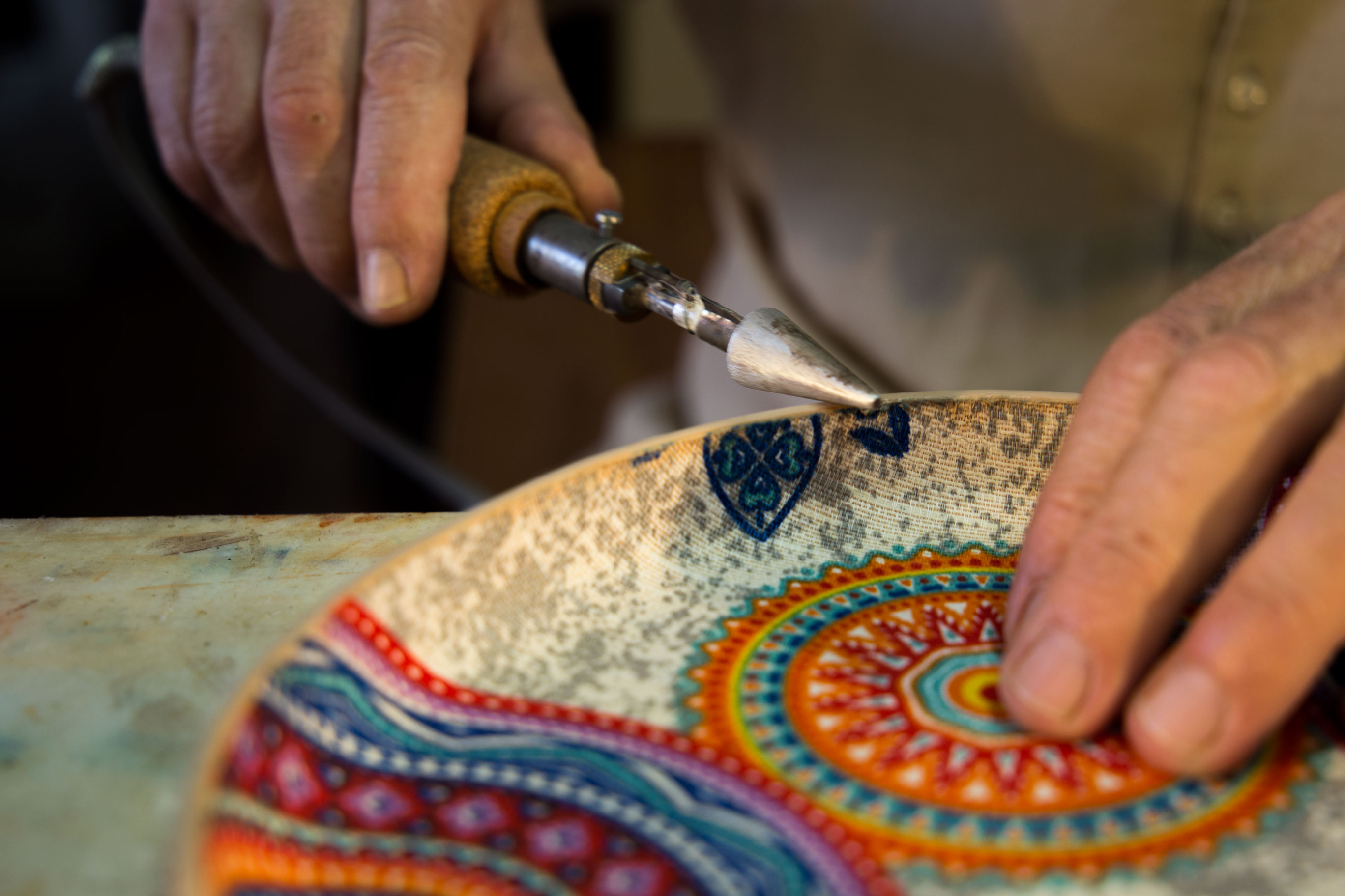 leather artist creating a dish