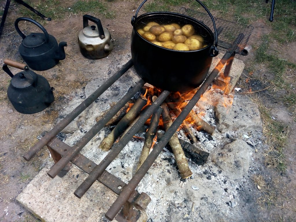 potatoes cooking over the fire; eco-camping in Devon