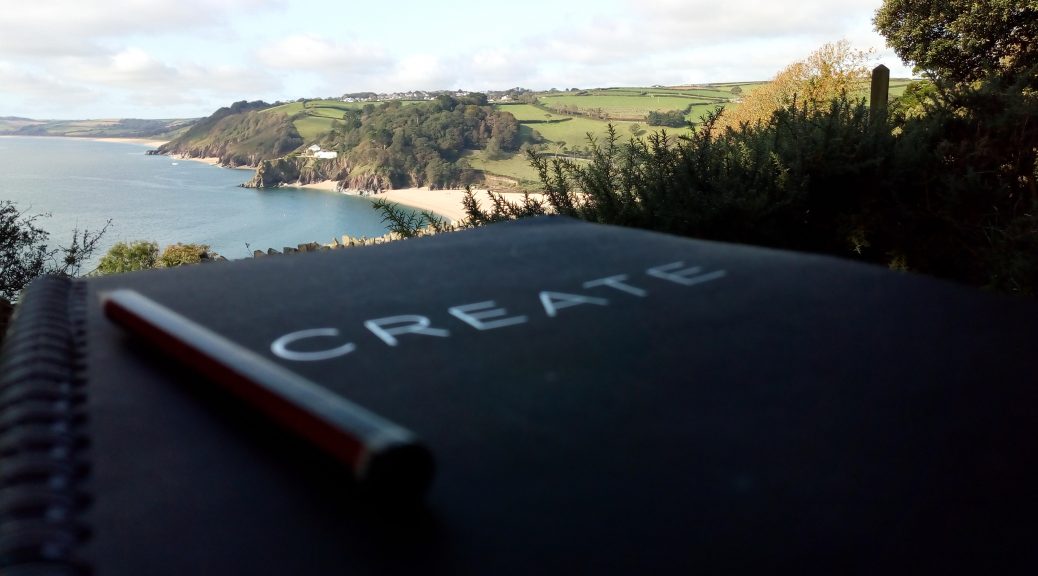 Writing for wellbeing A notebook outdoors with the a view of the sea in the background