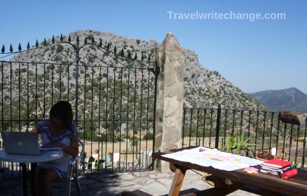 Writer at an outdoor table on a writing retreat in Spain