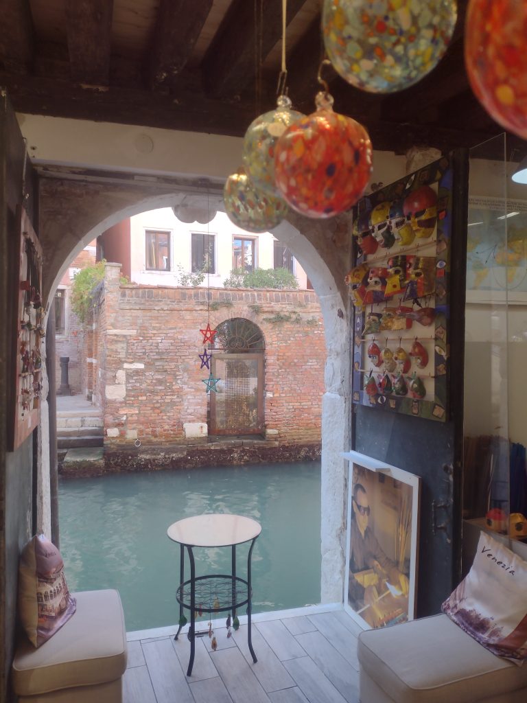 A shop window in Venice overlooking the canal